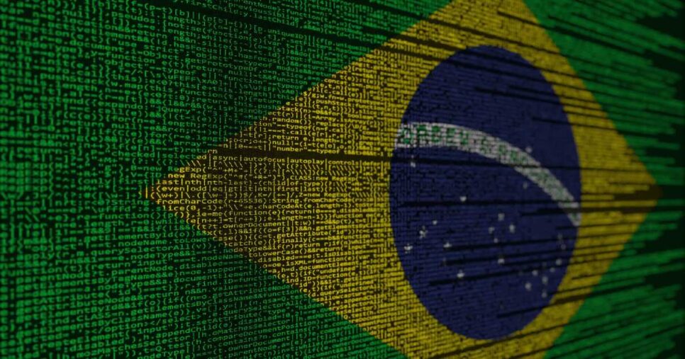 Imagem da bandeira do Brasil formada por linhas de código de programação, com caracteres e comandos em verde, amarelo, azul e branco, representando a integração entre tecnologia e identidade nacional (soberania, governo, confiança, digital)